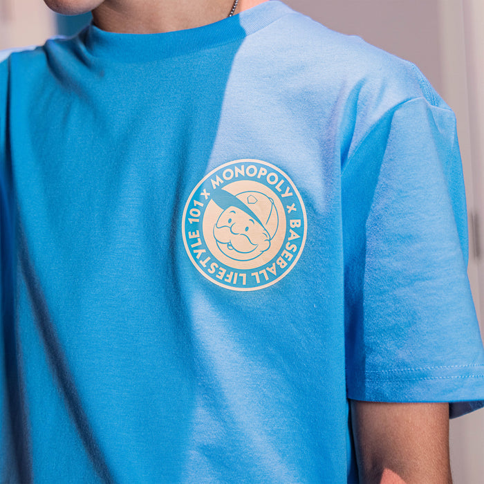Adult model wearing graphic tee with “BL101 x Monopoly” design